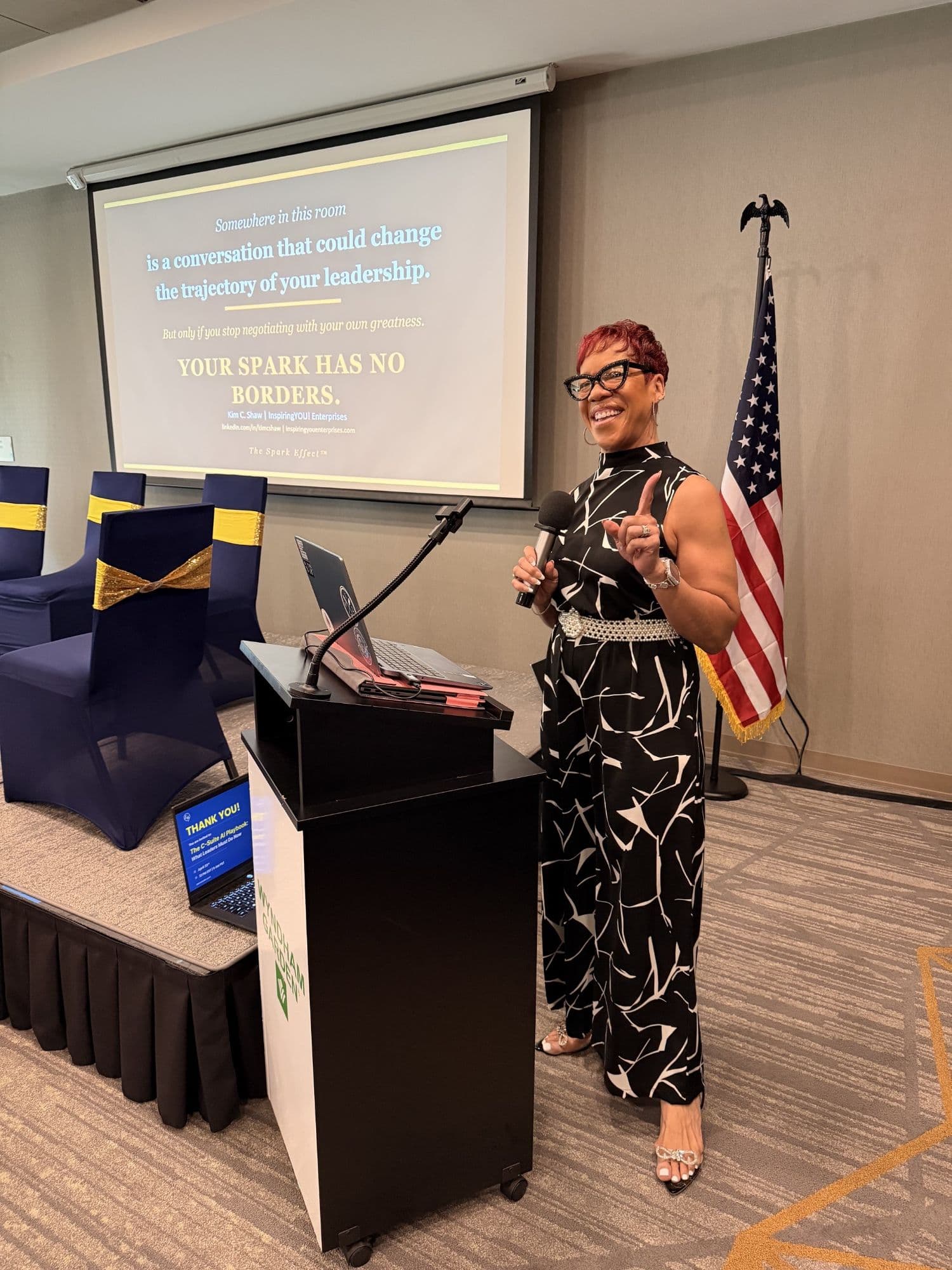 Kim C. Shaw presenting “Your Spark Has No Borders” at the podium